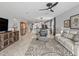 Open-concept living space with a ceiling fan, tile flooring, with a view of the dining and kitchen area at 17108 Se 111Th Terrace Rd, Summerfield, FL 34491