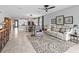 Open-concept living space with a ceiling fan, tile flooring, with a view of the dining and kitchen area at 17108 Se 111Th Terrace Rd, Summerfield, FL 34491