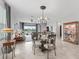 Open concept area with comfortable seating, dining table, and large windows showcases an inviting interior with plenty of natural light at 17108 Se 111Th Terrace Rd, Summerfield, FL 34491