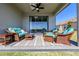 Covered patio with ceiling fan and wicker furniture, great for outdoor living at 17108 Se 111Th Terrace Rd, Summerfield, FL 34491