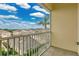 Balcony view overlooking lush greenery, a bright sky, and beautiful houses at 17406 Chateau Pine Way, Clermont, FL 34711
