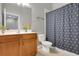 Bathroom with a vanity, a toilet, and a shower/tub with a polka dot shower curtain at 17406 Chateau Pine Way, Clermont, FL 34711