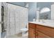 Bathroom with a vanity, a toilet, and a shower/tub combo with a decorative shower curtain at 17406 Chateau Pine Way, Clermont, FL 34711