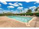 Sparkling community pool surrounded by lounge chairs and manicured landscaping at 17406 Chateau Pine Way, Clermont, FL 34711