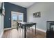 Bright dining room with natural light, wood floors, and a modern table set for four at 17406 Chateau Pine Way, Clermont, FL 34711