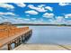 Beautiful view of the lake and community dock, perfect for boating and enjoying the water at 17406 Chateau Pine Way, Clermont, FL 34711