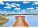 Scenic dock and gazebo on the lake, perfect for relaxing and enjoying the view at 17406 Chateau Pine Way, Clermont, FL 34711