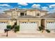 Charming townhome featuring a well-manicured lawn and a two-car garage, all under a bright blue sky at 17406 Chateau Pine Way, Clermont, FL 34711