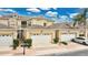 Well-kept townhome exterior with a two-car garage, manicured shrubs, and a neatly paved driveway at 17406 Chateau Pine Way, Clermont, FL 34711