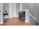 Hallway features a wood floor, white doors, and a bar setup, leading to the stairwell at 17406 Chateau Pine Way, Clermont, FL 34711