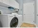 Modern laundry room equipped with a washer, dryer, and ample storage space at 17406 Chateau Pine Way, Clermont, FL 34711