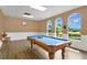 Recreation room featuring a classic pool table and bright windows at 17406 Chateau Pine Way, Clermont, FL 34711