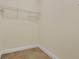 Empty walk-in closet features neutral walls, base trim and shelving unit at 17406 Chateau Pine Way, Clermont, FL 34711