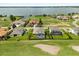Aerial view of homes with screened pools overlooking a large lake at 17700 Sawgrass Run, Tavares, FL 32778