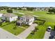 Aerial view of home with meticulous landscaping and paver driveway, and expansive golf course at 17700 Sawgrass Run, Tavares, FL 32778