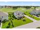 Beautiful aerial view of a meticulously landscaped home, backing onto a lush golf course at 17700 Sawgrass Run, Tavares, FL 32778