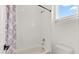 Clean bathroom with white tile and tub-shower combination at 17700 Sawgrass Run, Tavares, FL 32778