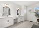 Elegant bathroom with double vanity, ornate mirrors, and contemporary fixtures offers a luxurious experience at 17700 Sawgrass Run, Tavares, FL 32778