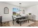 Bright dining area featuring stylish furniture and a beautiful outdoor view at 17700 Sawgrass Run, Tavares, FL 32778