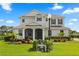 Charming home exterior with well-maintained landscaping and screened in porch at 17700 Sawgrass Run, Tavares, FL 32778