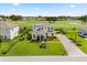 Beautiful two-story home boasts mature landscaping and a golf course view at 17700 Sawgrass Run, Tavares, FL 32778