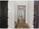 Welcoming hallway with beautiful hardwood floors and modern lighting at 17700 Sawgrass Run, Tavares, FL 32778