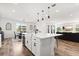 Open kitchen with a large island, modern appliances, and seamless flow to dining area at 17700 Sawgrass Run, Tavares, FL 32778