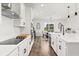 Modern kitchen featuring white cabinets, stainless steel appliances, and a large island at 17700 Sawgrass Run, Tavares, FL 32778