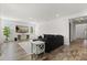 Comfortable living room showcasing an inviting dark sectional sofa and a modern media setup for entertainment at 17700 Sawgrass Run, Tavares, FL 32778