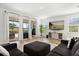 Inviting living area featuring a plush sofa, large windows, and a seamless transition to the outdoor patio at 17700 Sawgrass Run, Tavares, FL 32778