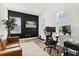 Office space with black accent wall, desk, dual monitors, and comfortable leather seating, promoting productivity and style at 17700 Sawgrass Run, Tavares, FL 32778