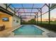 A sparkling screened pool with a serene outdoor view at dusk at 17700 Sawgrass Run, Tavares, FL 32778