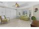 Bright bedroom featuring wood floors, built-in cabinets and a ceiling fan at 2077 Vickers Pl, The Villages, FL 32163
