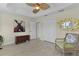 This cozy bedroom has wood floors and a decorative mirror at 2077 Vickers Pl, The Villages, FL 32163
