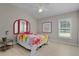 Cozy bedroom with wood floors, bright window, and colorful decor at 2077 Vickers Pl, The Villages, FL 32163