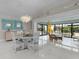 Bright dining area featuring tile floors, stylish light fixture, and access to lanai at 2077 Vickers Pl, The Villages, FL 32163