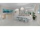 Elegant dining room featuring a large table, decorative lighting, and mirrored wall accent at 2077 Vickers Pl, The Villages, FL 32163