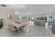 Expansive dining area with stylish chandelier, seamless flow to kitchen, and open-concept design at 2077 Vickers Pl, The Villages, FL 32163