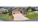 Aerial front view of a single-story home with a three-car garage and landscaped yard at 2077 Vickers Pl, The Villages, FL 32163