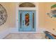 Charming front door with a colorful floral wreath, sidelights, and decorative accents at 2077 Vickers Pl, The Villages, FL 32163