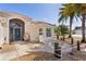 Inviting front entrance with a charming patio area and tropical landscaping at 2077 Vickers Pl, The Villages, FL 32163