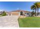Charming single-story home with a well-manicured lawn and a beautiful, patterned driveway at 2077 Vickers Pl, The Villages, FL 32163