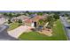 Charming home with manicured lawn, palm trees, and stone driveway at 2077 Vickers Pl, The Villages, FL 32163