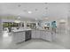 Open kitchen with an island, stainless steel appliances, and seamless flow to the living and dining areas at 2077 Vickers Pl, The Villages, FL 32163