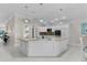 Bright kitchen features a center island, granite countertops, and stainless-steel appliances at 2077 Vickers Pl, The Villages, FL 32163