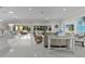Bright, open-concept living space with beach decor, tile floors, and seamless flow to outdoor areas at 2077 Vickers Pl, The Villages, FL 32163
