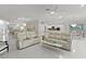 Bright and airy living room featuring neutral tones, tile flooring, and modern furnishings at 2077 Vickers Pl, The Villages, FL 32163
