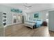 Spacious main bedroom with light blue walls, wood floors, and ample closet space at 2077 Vickers Pl, The Villages, FL 32163