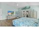 Large main bedroom featuring wood floors, ample closet space, and a TV at 2077 Vickers Pl, The Villages, FL 32163