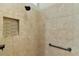 Tiled shower with built-in niche, sleek fixtures, and grab bar for safety at 2077 Vickers Pl, The Villages, FL 32163